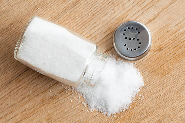 istock An open salt shaker on a wooden table 120660021