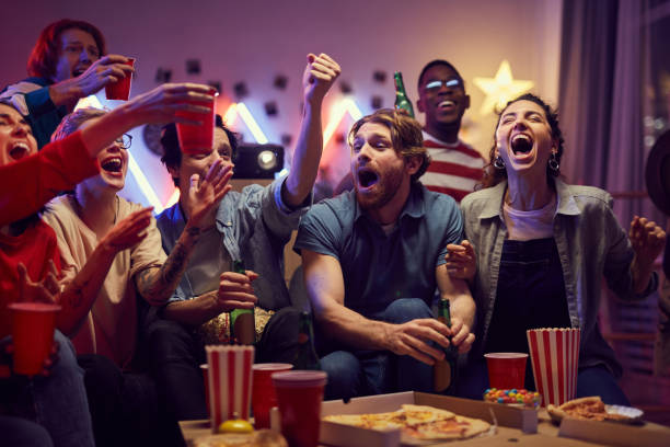 istock Group of fans having fun at home 1206600490