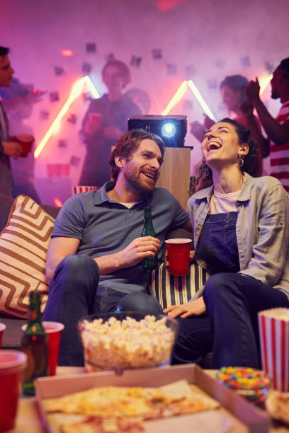 istock Happy couple sitting at party 1206600583