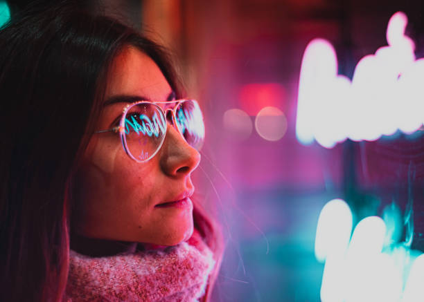неоновый свет, отраженный на очках девушки - pink city стоковые фото и изображения