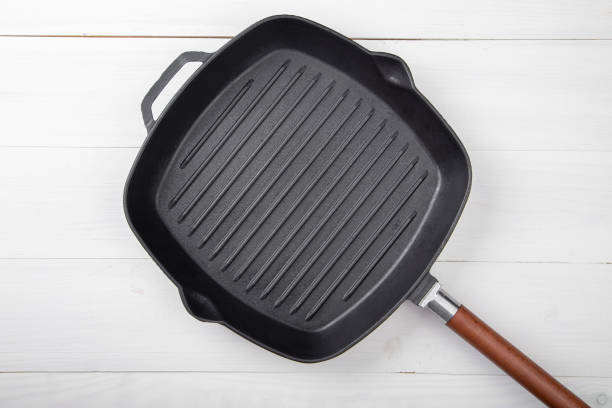 istock Cast-iron grill pan on a wooden surface. 1206601905