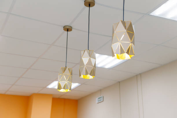 istock Three beautiful chandeliers on the ceiling in a clothing store 1206602214