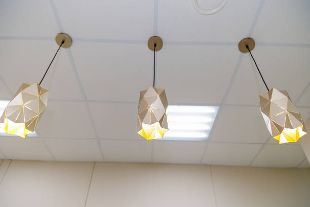 istock Three beautiful chandeliers on the ceiling in a clothing store 1206602224