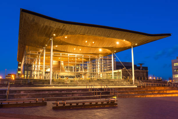 The Senedd, Welsh Parliament, Cardiff, Wales, UK Wide angle view of The Senedd at dusk, Welsh Parliament, Cardiff, Wales, UK parliament building photos stock pictures, royalty-free photos & images