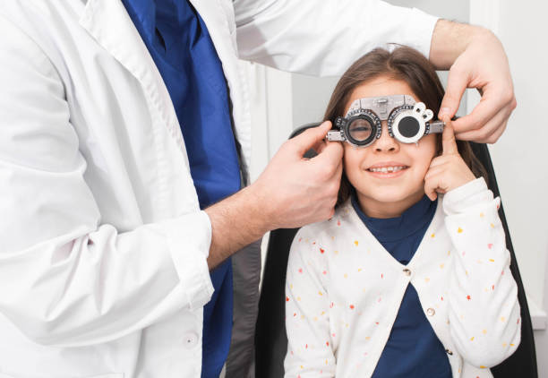 istock Child with optometrist trial frame in vision clinic. Ophthalmologist helping select glasses for treatment of vision 1206604042