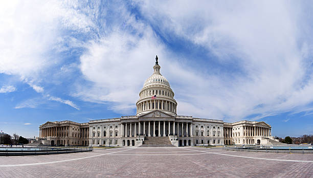 US Capitol - Government building Wide angle panorama of the US United States Capitol building for Democrat Republican Government Senate and House congress parties under a summer blue sky with white clouds. library of congress stock pictures, royalty-free photos & images
