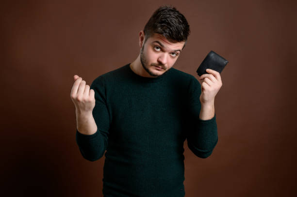 istock Man with brown hair showing wallet 1206605622