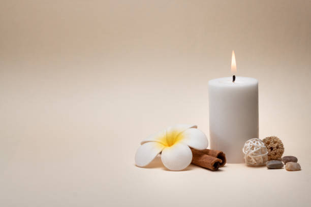 istock Beautiful spa composition with candle, frangipani flower and other decor elements. 1206606755