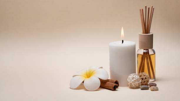 Beautiful spa composition with candle, frangipani flower and other decor elements. stock photo