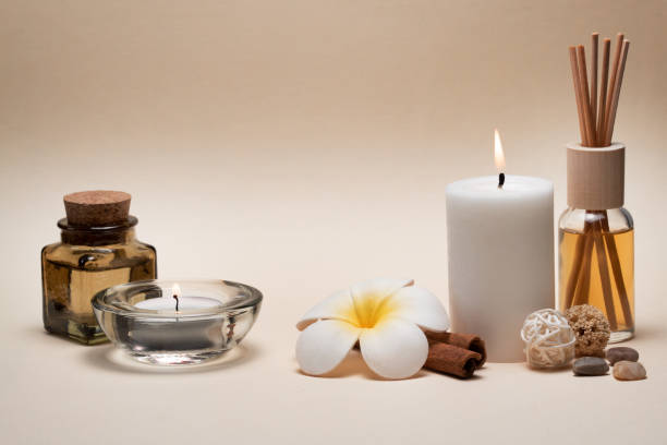 istock Beautiful spa composition with candles, frangipani flower, oil flasks and other decor elements. 1206607007
