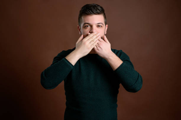 istock Young man with brown showing symbols of three wise monkeys 1206607016