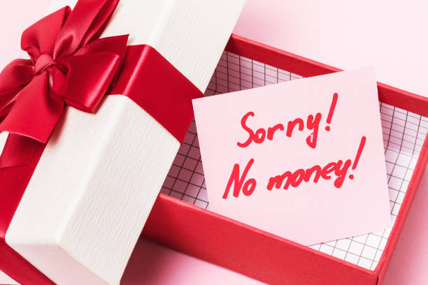 istock An open gift box with a note inside on a pink background. Concept on the topic of lack of money for gifts 1206607128