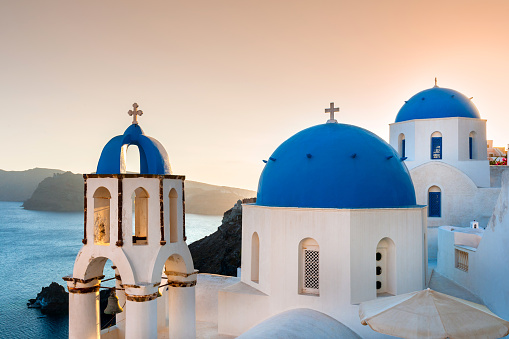 Looking over the buildings of Oia at sunset, Santorini, Greece.
