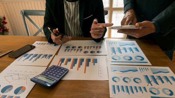 istock 2 businessmen who point to tablets and talk about working at the table. 1206613334