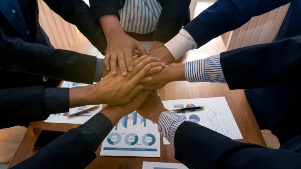istock Large business team, showing unity with their hands together, top view 1206613361