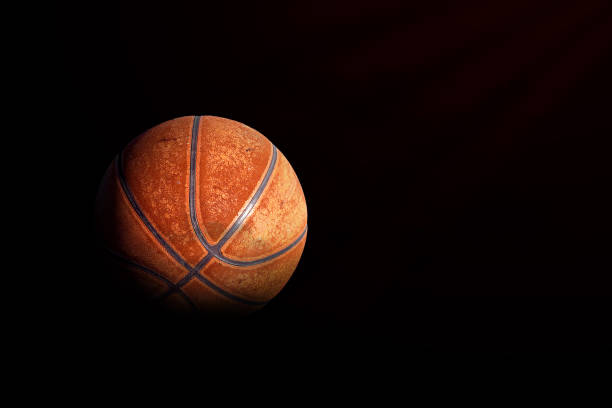 istock sport concept. old basketball on black background 1206614578