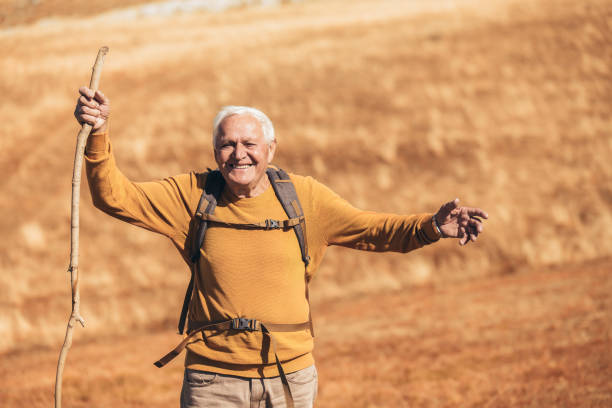istock Senior man on hike through beautiful countryside in autumn. 1206614603