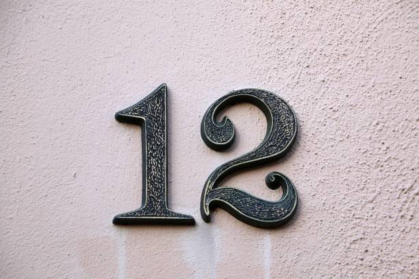 istock old house number twelve at a white house wall 1206614616