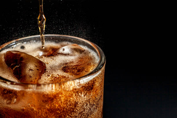 istock Fizz sparkling Cola water Refreshing bubbly Soda Pop with Ice Cubes. Cold soft drink cola carbonated liquid fresh and cool iced drink in a glasses . Refreshing and quench thirst concept . 1206615595