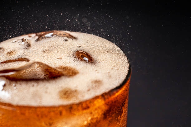 istock Fizz sparkling Cola water Refreshing bubbly Soda Pop with Ice Cubes. Cold soft drink cola carbonated liquid fresh and cool iced drink in a glasses . Refreshing and quench thirst concept . 1206615626