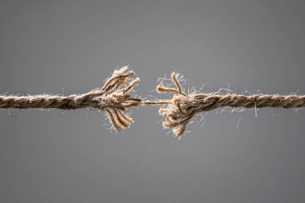Frayed rope about to break Frayed rope about to break concept for stress, problem, fragility or precarious business situation physical pressure stock pictures, royalty-free photos & images