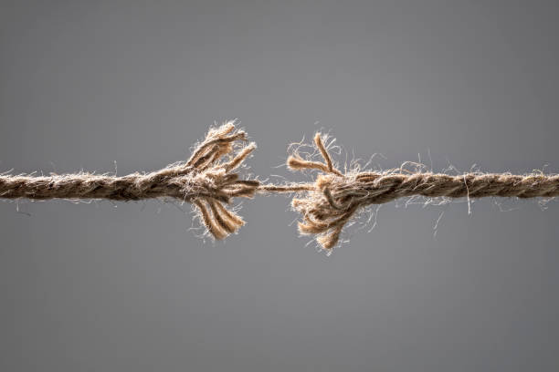 Frayed rope about to break Frayed rope about to break concept for stress, problem, fragility or precarious business situation weakness stock pictures, royalty-free photos & images