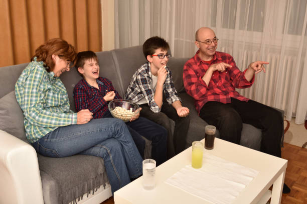 istock Family watching funny movie or program on TV 1206616821