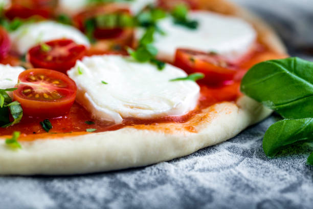 istock Prepering margherita pizza with mozzarella for baking 1206618114