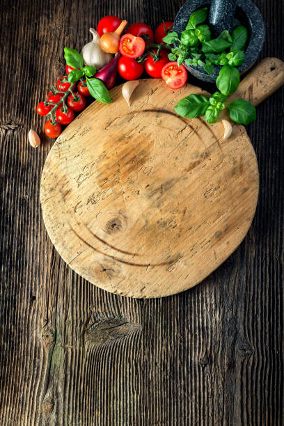 istock wooden board with vegetables, herbs and a stone grinder 1206618454