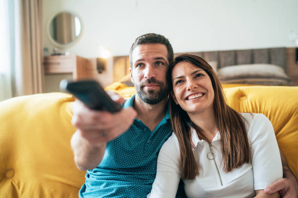 istock Happy couple watching tv 1206620331