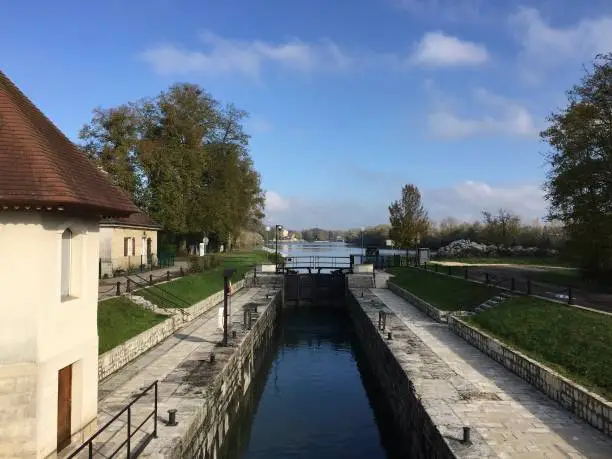Photo of The Canal du Rhône au Rhin in the vicinity of Dole, France. This is one of the important watershed canals of the French waterways, connecting the Rhine to the Saône and the Rhône and thereby the North Sea and the Mediterranean.