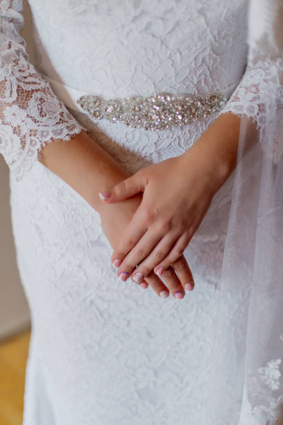 istock Young bride hands on a wedding dress 1206621810