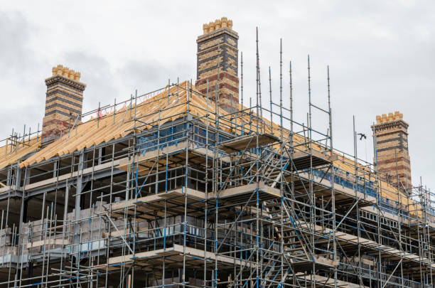 gerüstwird errichtet, während ein neues dach installiert wird - restoring scaffolding built structure home improvement stock-fotos und bilder