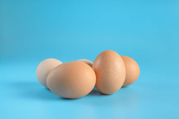istock Five fresh brown chicken eggs on a blue background. Healthy good nutrition. Natural organic farm products. 1206625665