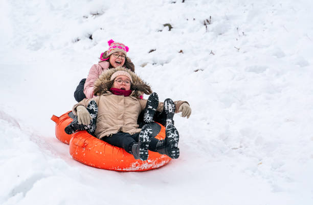 istock Kids sledding tubes on snowy hill in winter 1206626451