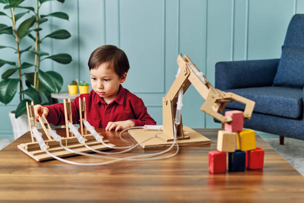 istock 2-3 years old child playing with robotic arm. Robotic is his technology of future. 1206627373