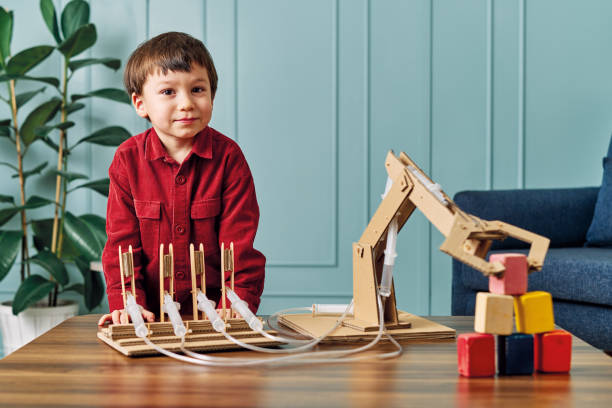istock 2-3 years old child playing with robotic arm. Robotic is his technology of future. 1206627874