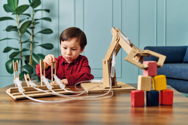 istock 2-3 years old child playing with robotic arm. Robotic is his technology of future. 1206630153