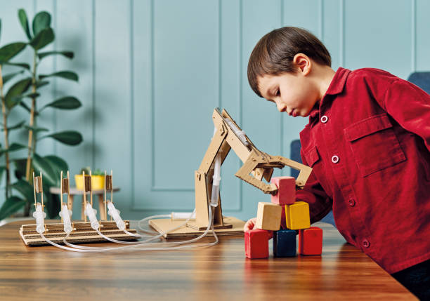 istock 2-3 years old child playing with robotic arm. Robotic is his technology of future. 1206630320