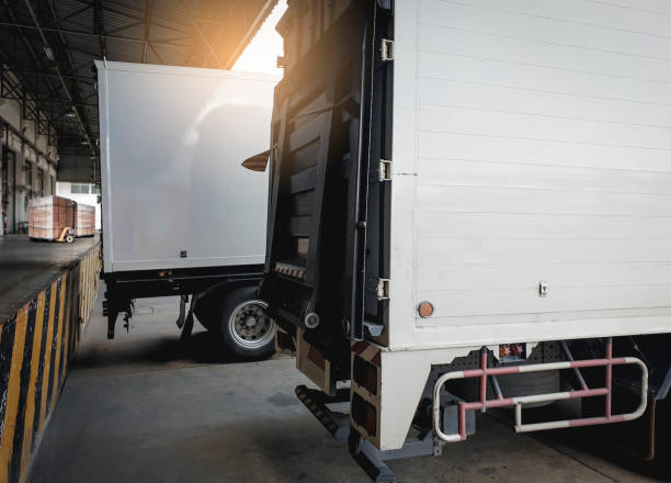 istock Truck container docking load shipment goods at warehouse, Road freight industry delivery logistics and transport. 1206630482
