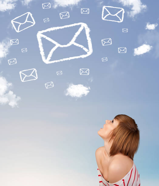 istock Young girl looking at mail symbol clouds on blue sky 1206630581
