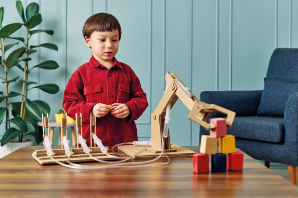 istock 2-3 years old child playing with robotic arm. Robotic is his technology of future. 1206630932