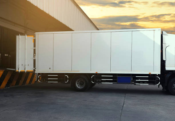 istock White truck docking load cargo shipment at warehouse. Road freight industry logistics. 1206631488
