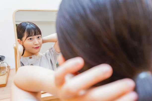 istock Young woman setting her hair 1206633826