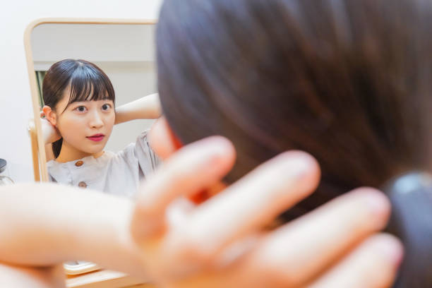 istock Young woman setting her hair 1206633906