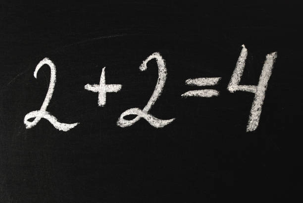 istock Word two plus two equals four written in white chalk on a black chalkboard. 1206635112
