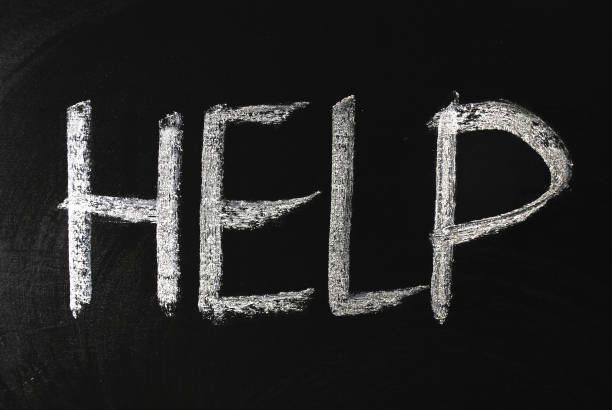 istock Help word written in white chalk on a black chalkboard. 1206635151