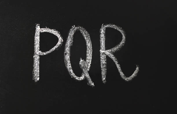 istock PQR alphabet letters written in white chalk on a black chalkboard. 1206635301