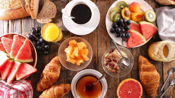 istock full breakfast with coffee cup, tea cup, croissant, bread and fruit 1206638575