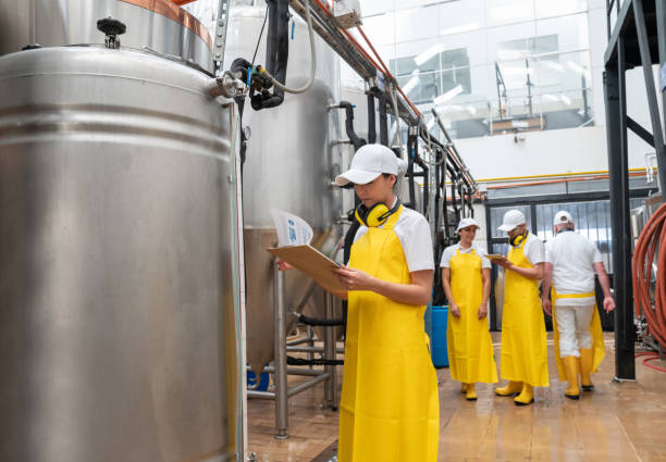istock Workers working at a brewery supervising the storage tanks 1206641616